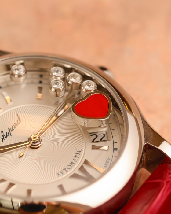 Macro view of the five dancing diamonds and red carnelian heart on the Chopard Happy Sport Cortina 50th Anniversary.