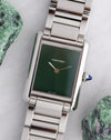 Cartier Tank Must WSTA0056 with minimalist green lacquer dial and stainless steel Cartier bracelet photographed beside green mineral specimens.