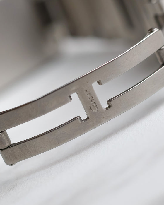 Close-up of the signed Cartier folding clasp fitted to the stainless steel bracelet.