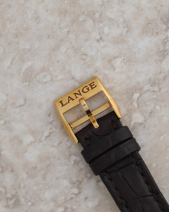 Signed A. Lange & Söhne 18K yellow-gold pin buckle fitted to the brown leather strap.