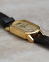 Side profile of the yellow-gold Arkade case showing its polished surfaces and angular lugs.