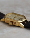 Detailed side view of the Arkade case, crown and date corrector in 18K yellow gold.