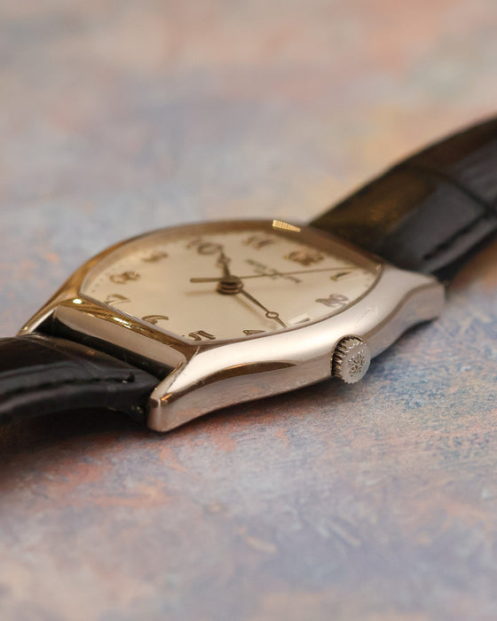 Side profile of the Patek Philippe Gondolo 5030G showing its curved tonneau case and signed crown.