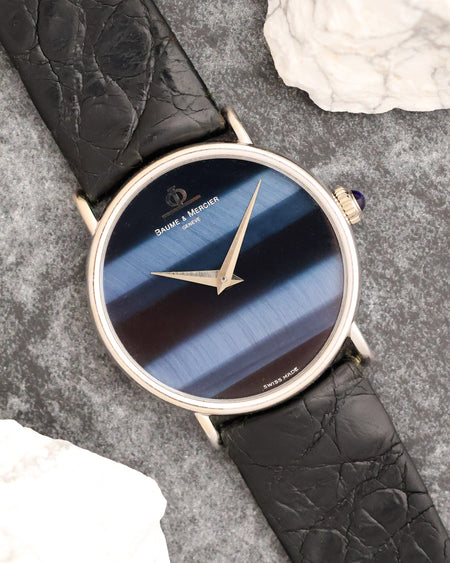 Angled view of the Baume & Mercier 35103 showing the blue and black chatoyance of its falcon’s eye dial.