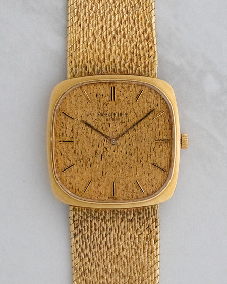 Front view of Patek Philippe Golden Ellipse Ref. 3566 in yellow gold with textured gold dial and integrated bracelet.