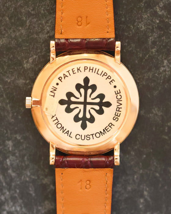 Rose-gold caseback of the Patek Philippe 5022R with Patek Philippe International Customer Service sticker.