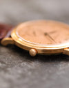 Macro view of the signed crown and slim polished rose-gold case of the Patek Philippe 5022R.