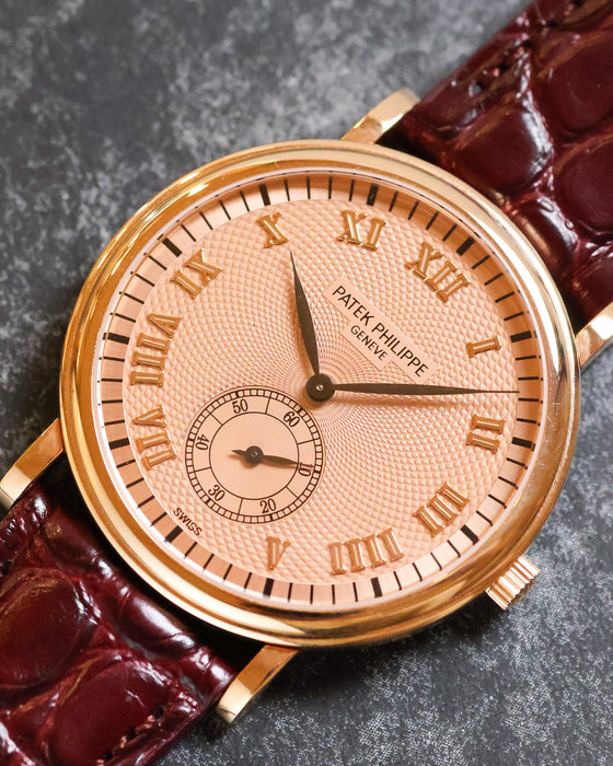 Angled dial close-up showing the intricate guilloché pattern and applied rose-gold Roman numerals of the Patek Philippe 5022R.