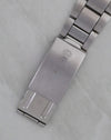 Exterior Rolex-signed clasp on folded stainless-steel Oyster bracelet.