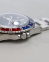 Side profile of Rolex GMT-Master 1675 showing acrylic crystal, bezel and crown.