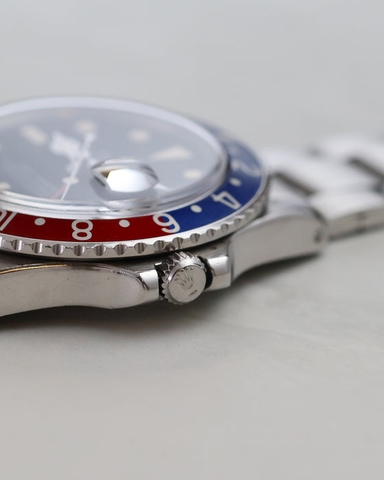 Side profile of Rolex GMT-Master 1675 showing acrylic crystal, bezel and crown.