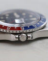 Macro side view of Rolex GMT-Master 1675 crown and acrylic crystal.