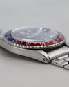 Side profile of Rolex GMT-Master 1675 showing domed acrylic crystal and folded bracelet.