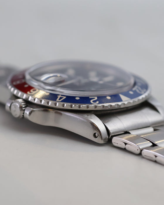 Low-angle view of Rolex GMT-Master 1675 with blue bezel and acrylic crystal.