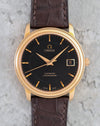Straight-on view of the Omega De Ville Prestige black dial with applied rose-gold markers.