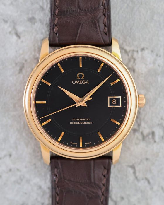Straight-on view of the Omega De Ville Prestige black dial with applied rose-gold markers.