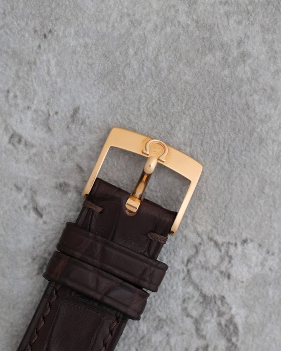 Original Omega 18K rose-gold pin buckle fitted to the brown leather strap.