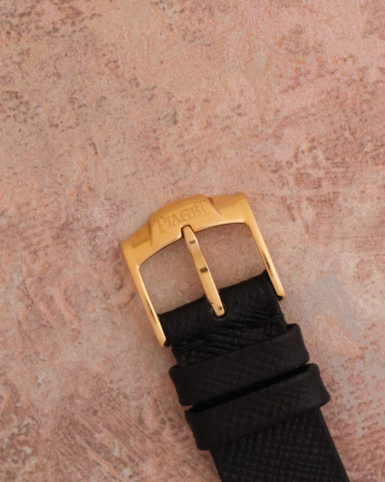 Signed Piaget 18K rose-gold buckle fitted to the black leather strap.