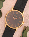 Angled view of the Piaget 80035 showing its grey dial, rose-gold Roman numerals and slim round case.
