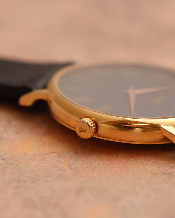 Close-up of the signed Piaget crown and polished 18K rose-gold case.