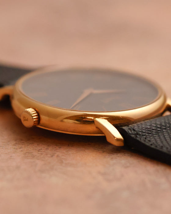 Detailed side view of the Piaget 80035 showing its rose-gold case, lug and black leather strap.