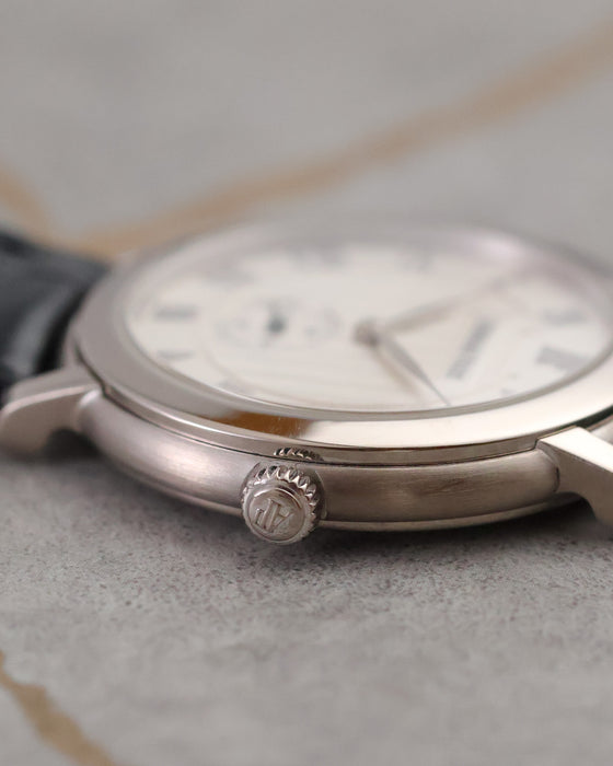 Macro view of the signed Audemars Piguet crown on the 18K white-gold Jules Audemars case.