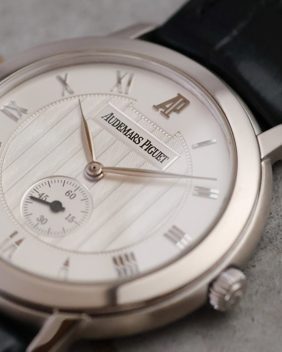 Macro view of the silvered guilloché dial with applied Roman numerals, small seconds and Audemars Piguet signature.