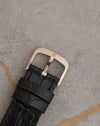 Signed 18K white-gold Audemars Piguet pin buckle fitted to the black leather strap.
