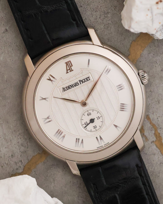 Angled dial view highlighting the engine-turned centre, applied Roman numerals and subsidiary seconds.