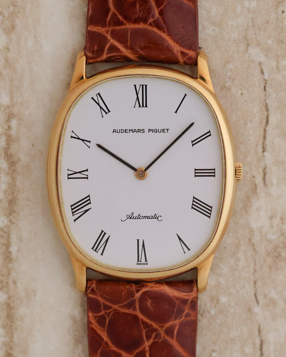 Front view of Audemars Piguet Ref. 4083 in 18K yellow gold with white Roman numeral dial and brown leather strap.