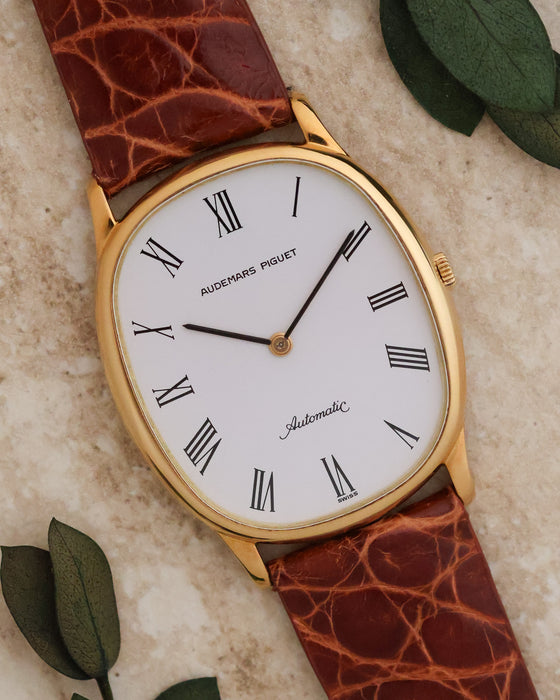 Angled front view of Audemars Piguet Ref. 4083 showing its elliptical yellow-gold case and white dial.