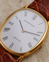 Close-up of the white dial with elongated Roman numerals, black hands and cursive Automatic signature.