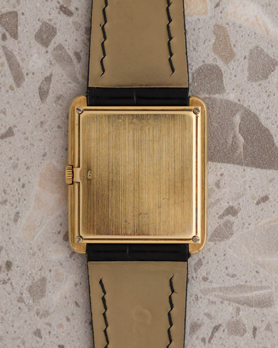 Caseback of the vintage Audemars Piguet rectangular manual-winding watch in yellow gold on a black leather strap.