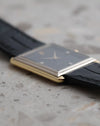 Low side profile showing the stepped white gold bezel above the yellow gold case of the Audemars Piguet rectangular watch.