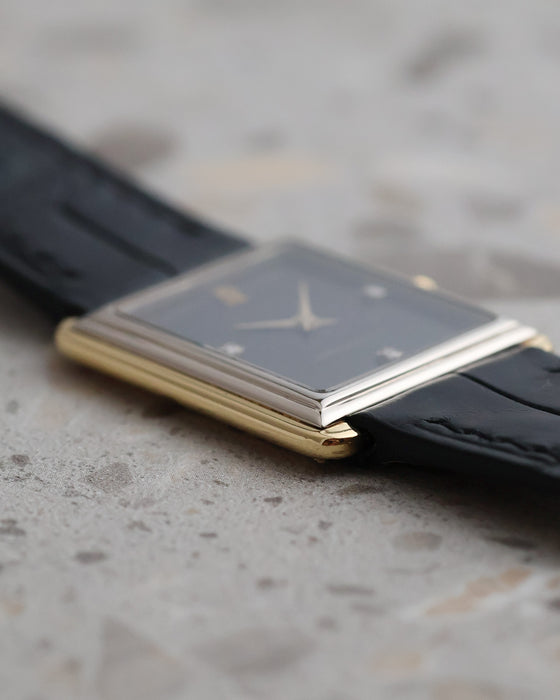 Low side profile showing the stepped white gold bezel above the yellow gold case of the Audemars Piguet rectangular watch.