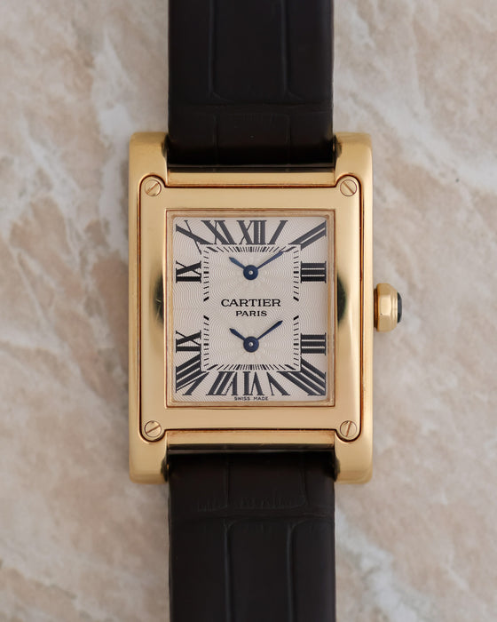Front view of the Cartier Tank à Vis Dual Time showing its vertically stacked dual-time display.