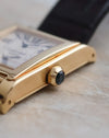 Side profile of the 18K yellow-gold Tank à Vis showing its faceted sapphire-set crown.