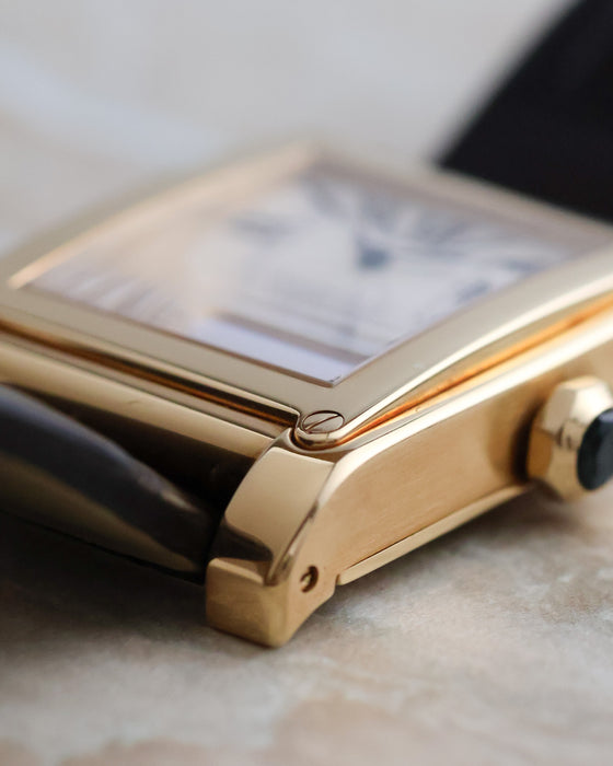 Close-up of the Tank à Vis case construction, exposed bezel screw and brushed yellow-gold case flank.