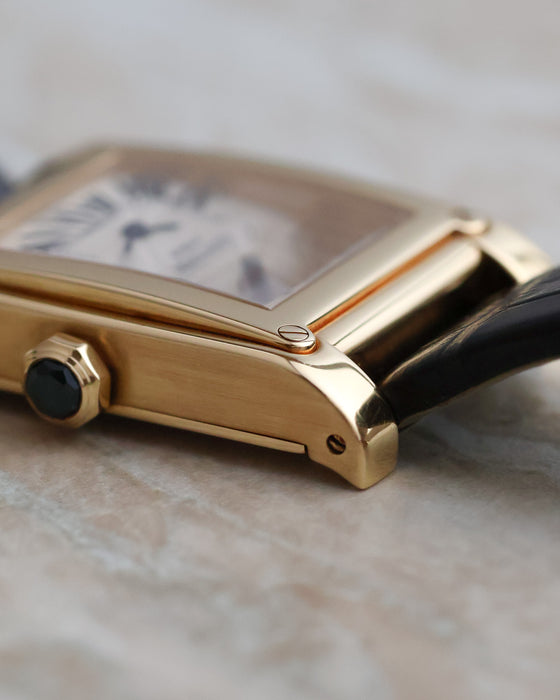 Macro view of the polished bezel, exposed corner screw and architectural lug of the Cartier Tank à Vis.