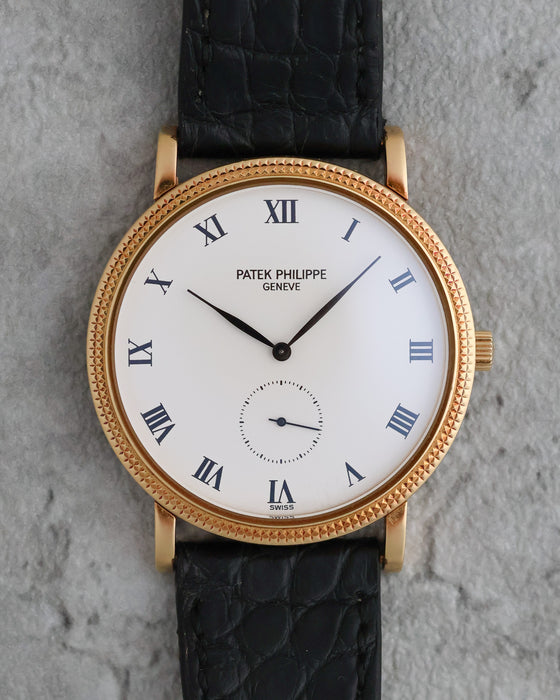 Front view of the Patek Philippe Calatrava 3919J showing its white Roman numeral dial and Clous de Paris bezel.