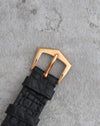 Original 18K yellow gold Patek Philippe tang buckle fitted to the black leather strap.