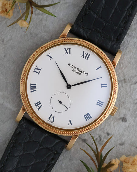 Angled view of the Patek Philippe Calatrava 3919J highlighting its Roman numeral dial and hobnail bezel.