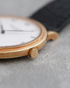 Macro photograph of the signed Patek Philippe crown and Clous de Paris bezel.