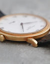 Close side view showing the yellow gold case and sharply defined hobnail bezel of the Patek Philippe 3919J.