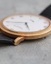 Profile view of the Patek Philippe Calatrava 3919J showing its curved lugs and textured bezel.