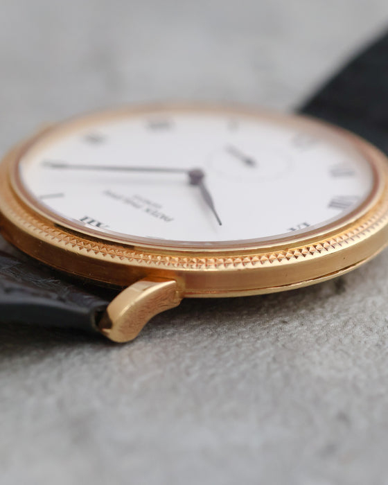 Profile view of the Patek Philippe Calatrava 3919J showing its curved lugs and textured bezel.
