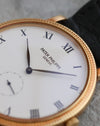 Macro view of the white dial, black Roman numerals and leaf-shaped hands of the Patek Philippe Calatrava 3919J.