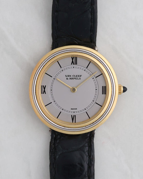 Van Cleef & Arpels Disco Volante G1525 in 18K yellow and white gold with silver dial and black leather strap.