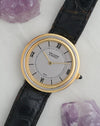 Angled view of the two-tone Van Cleef & Arpels Disco Volante with silver dial and concentric case.