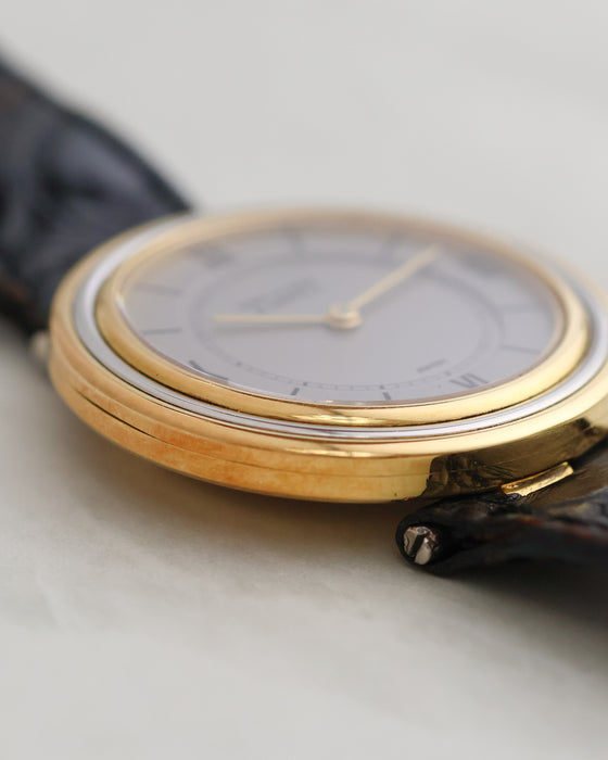 Macro view of the layered yellow and white gold bezel construction.
